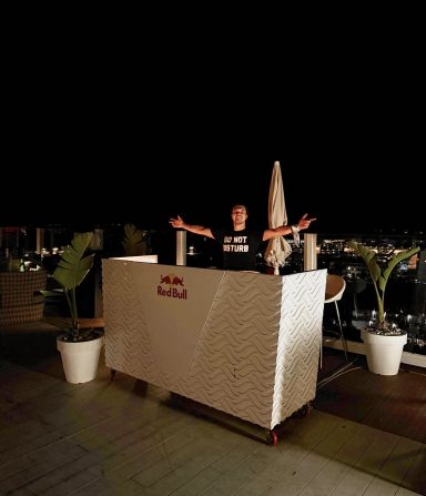 ROOM:SRVC rooftop DJ set at night with Red Bull stage